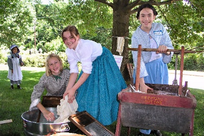 Photo of WNCHA History Club girls washing clothes the 19th century way.