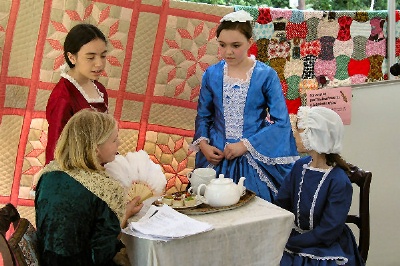 Photo of young ladies performing an American Girl play.
