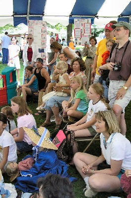 Photo of proud parents and friends watching a performance of an American Girl play.