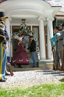 Photo of a Civil War wedding ceremony in front of the Smith-McDowell House Museum.